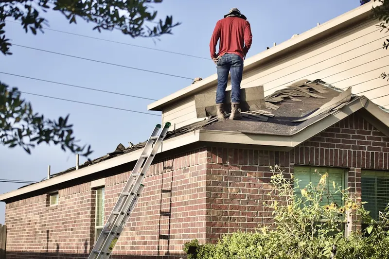 Professional roofer working on a residential roof in Trinway